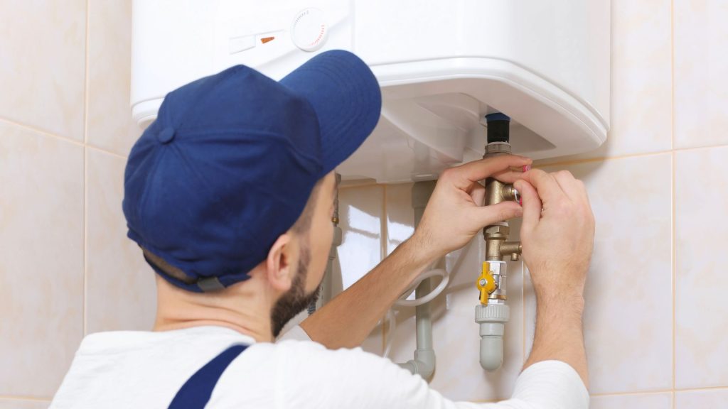 Man Replacing Water Heater in Bathroom